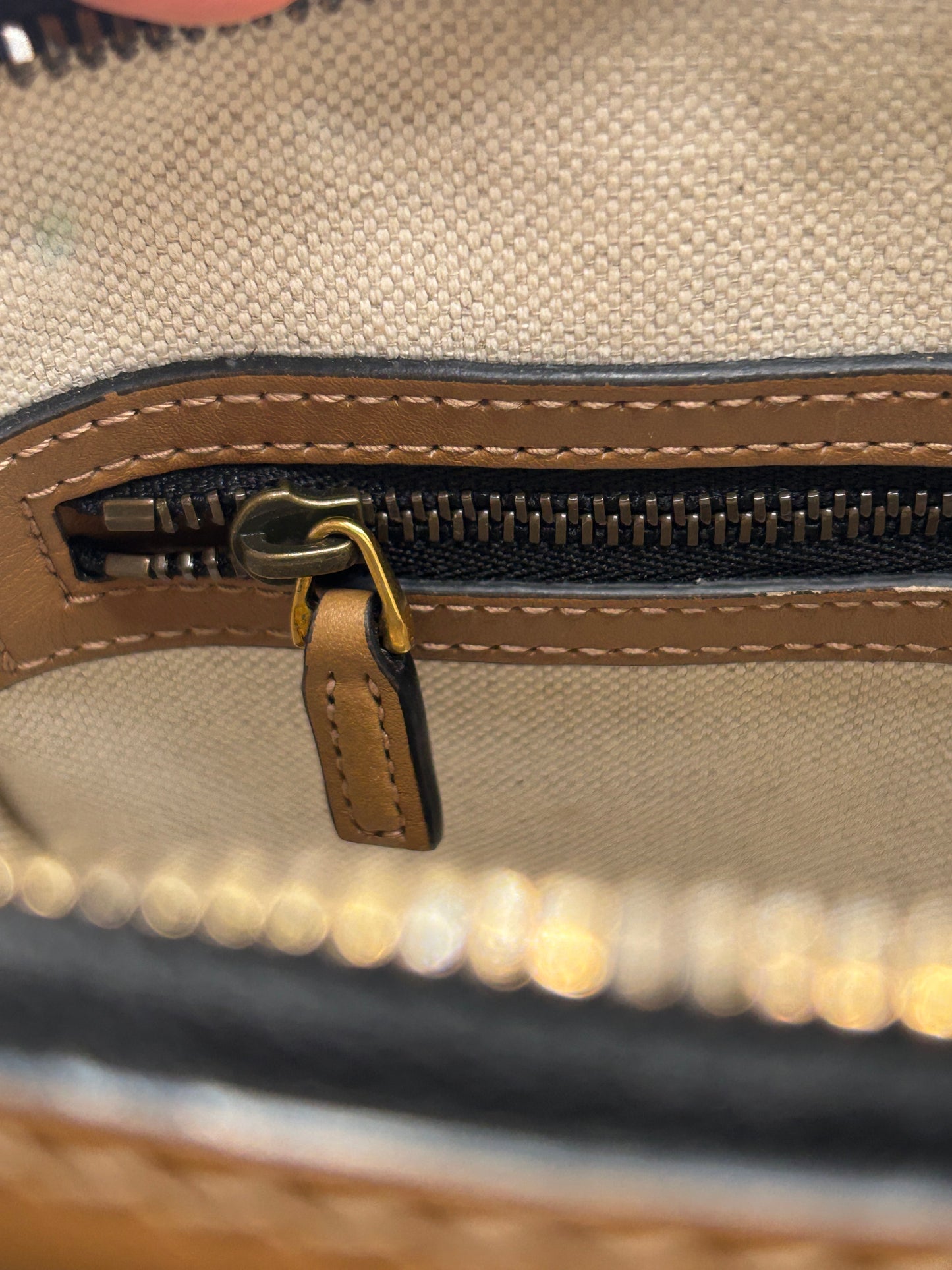 Gucci Bauletto mini top handle bag in black GG canvas and tan leather trim.