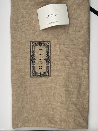 Gucci Bauletto mini top handle bag in black GG canvas and tan leather trim.