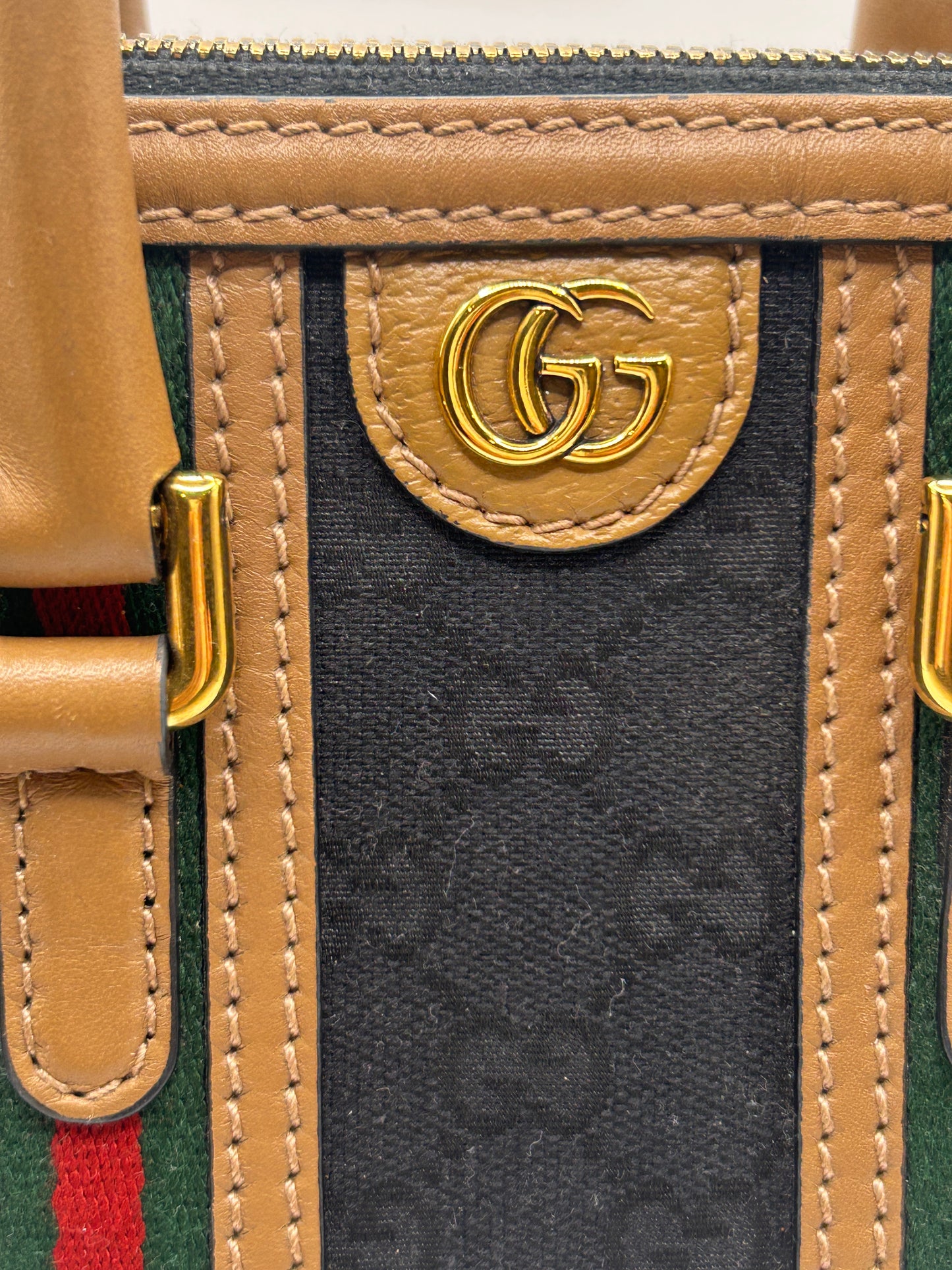 Gucci Bauletto mini top handle bag in black GG canvas and tan leather trim.