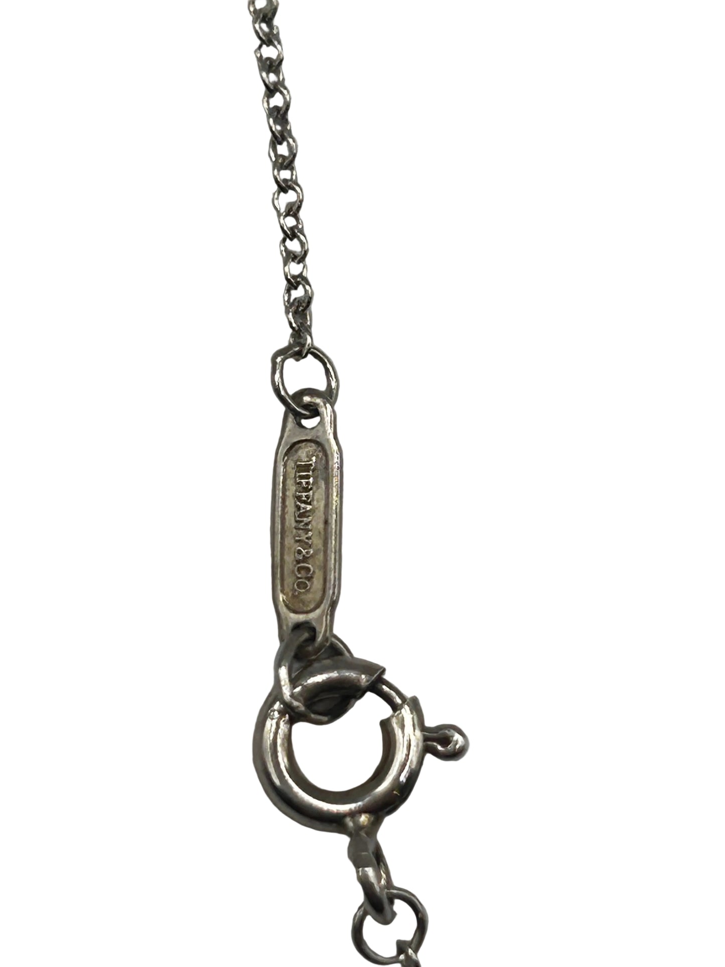 Tiffany & Co. 1837
Interlocking Circles Pendant in sterling silver, highlighted by its signature engraved hallmark and interlocking ring design.