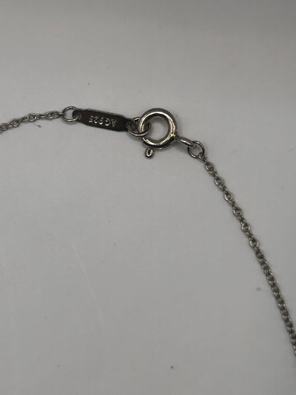 Tiffany & Co. 1837
Interlocking Circles Pendant in sterling silver, highlighted by its signature engraved hallmark and interlocking ring design.