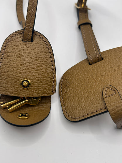 Gucci Bauletto mini top handle bag in black GG canvas and tan leather trim.