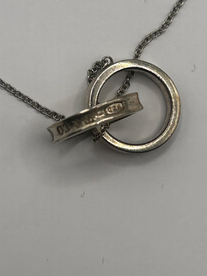 Tiffany & Co. 1837
Interlocking Circles Pendant in sterling silver, highlighted by its signature engraved hallmark and interlocking ring design.