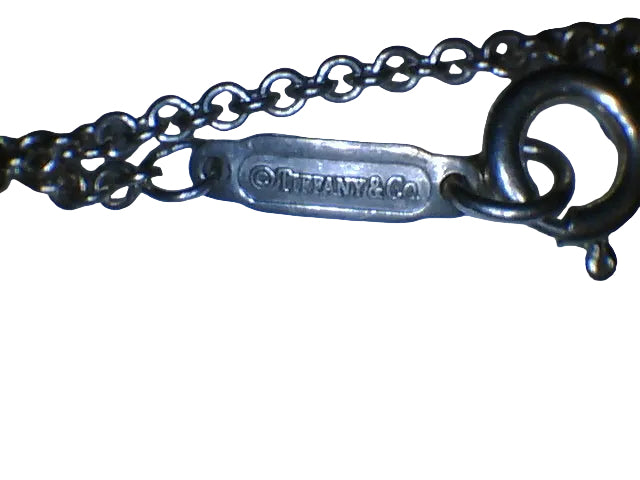 Tiffany & Co. 1837
Interlocking Circles Pendant in sterling silver, highlighted by its signature engraved hallmark and interlocking ring design.