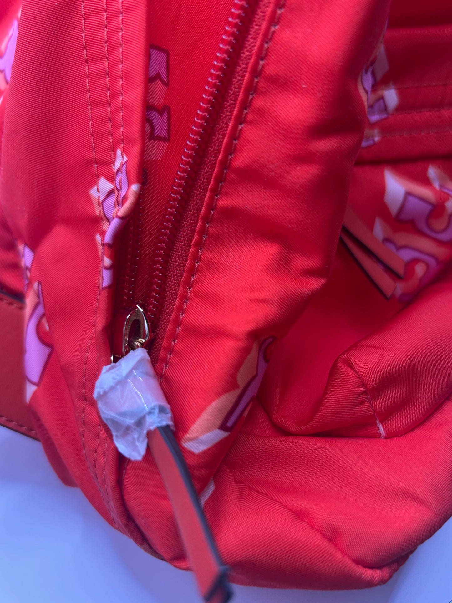 Tory Burch Ella Printed Backpack featuring a crazy logo allover pattern