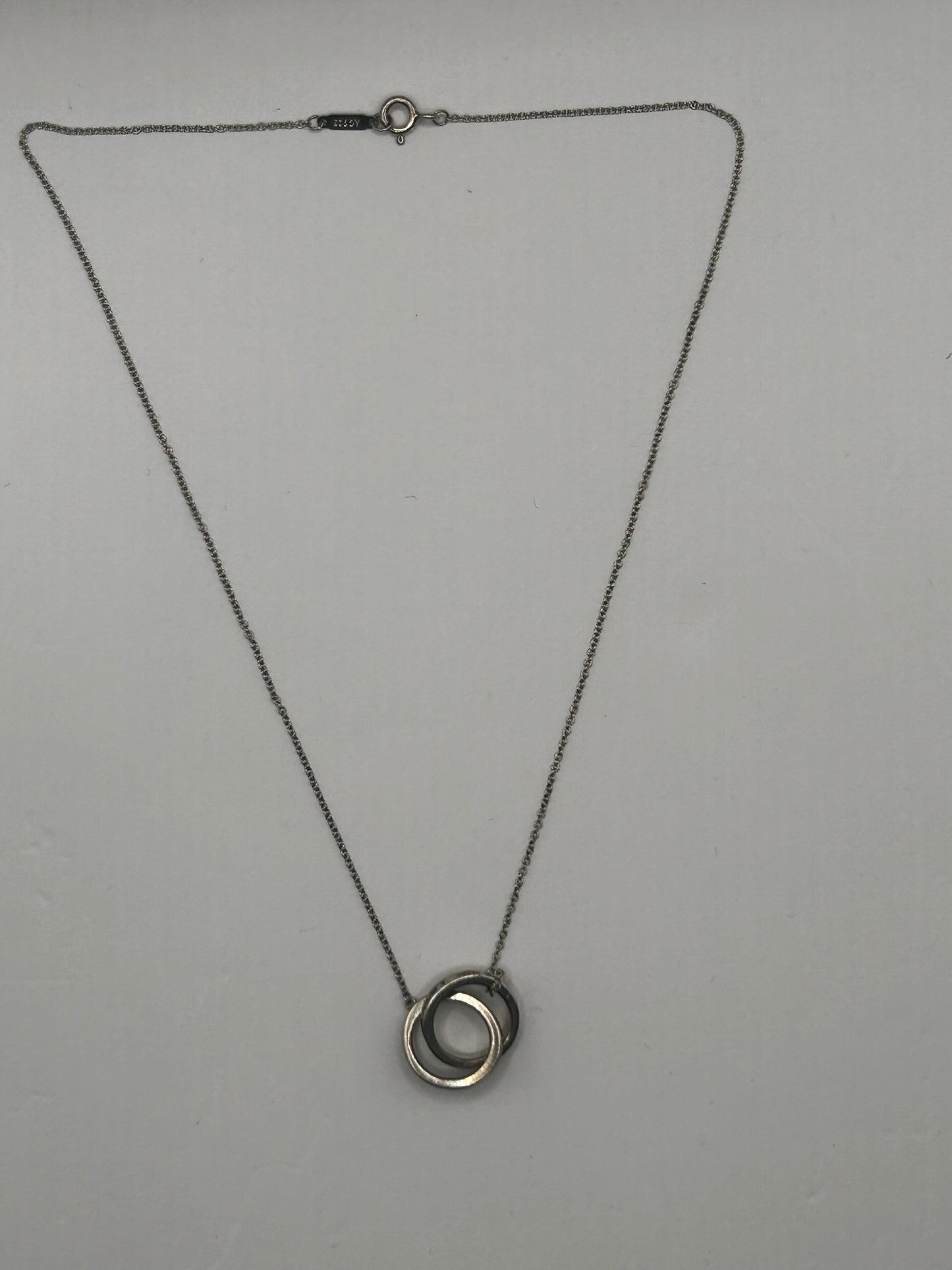 Tiffany & Co. 1837
Interlocking Circles Pendant in sterling silver, highlighted by its signature engraved hallmark and interlocking ring design.