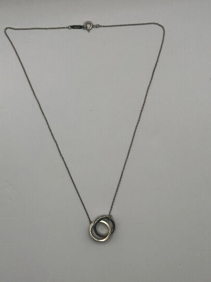 Tiffany & Co. 1837
Interlocking Circles Pendant in sterling silver, highlighted by its signature engraved hallmark and interlocking ring design.