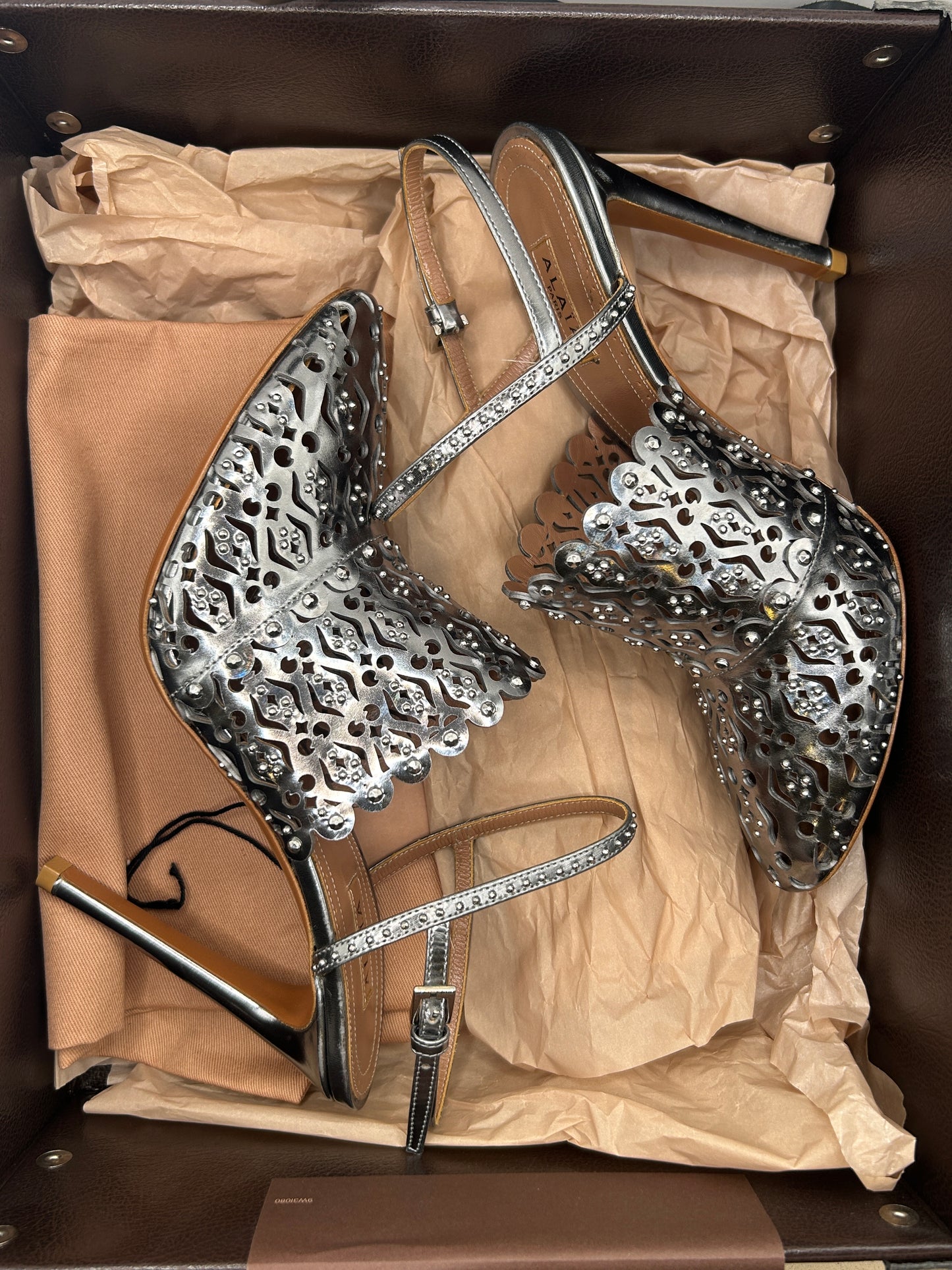 ALAIA Laser-Cut Studded
Pumps, Silver