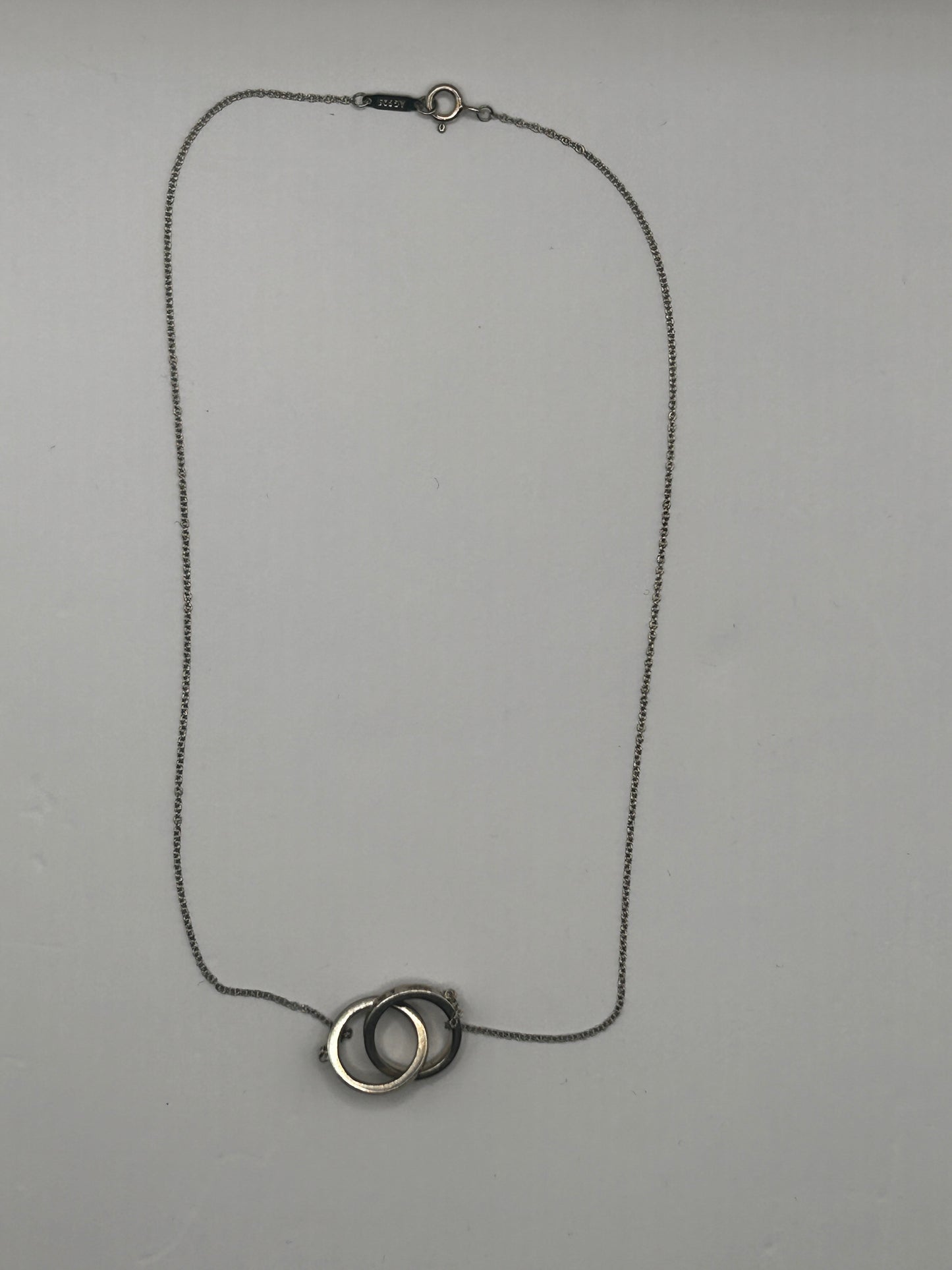 Tiffany & Co. 1837
Interlocking Circles Pendant in sterling silver, highlighted by its signature engraved hallmark and interlocking ring design.