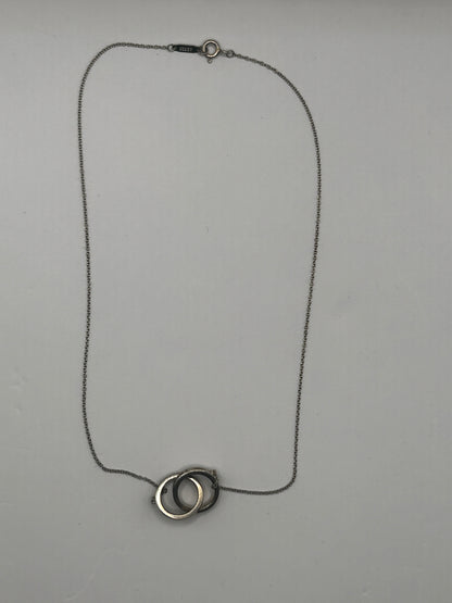 Tiffany & Co. 1837
Interlocking Circles Pendant in sterling silver, highlighted by its signature engraved hallmark and interlocking ring design.