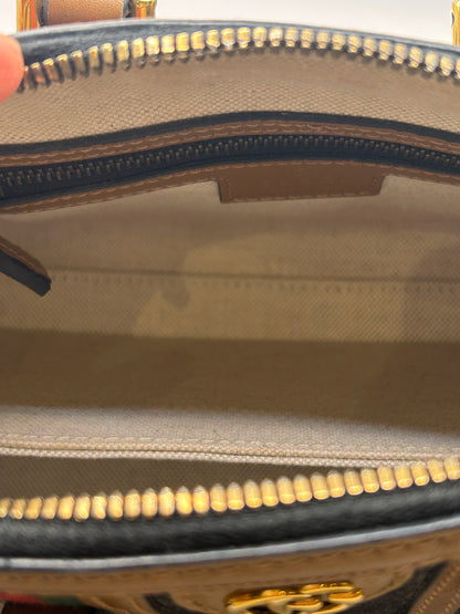 Gucci Bauletto mini top handle bag in black GG canvas and tan leather trim.