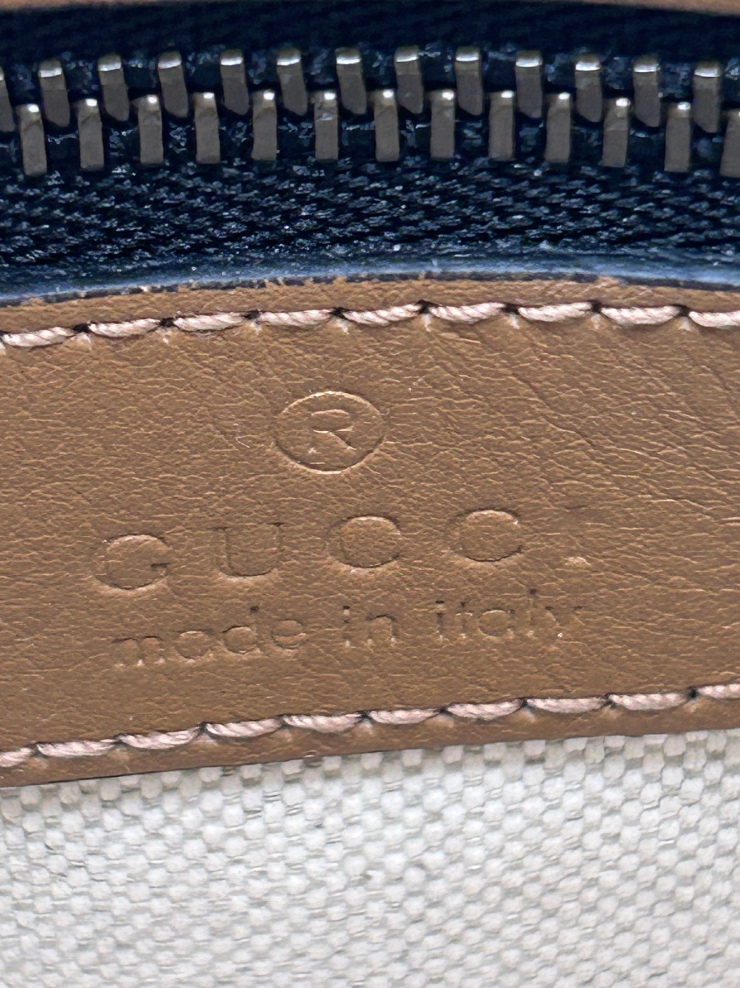 Gucci Bauletto mini top handle bag in black GG canvas and tan leather trim.