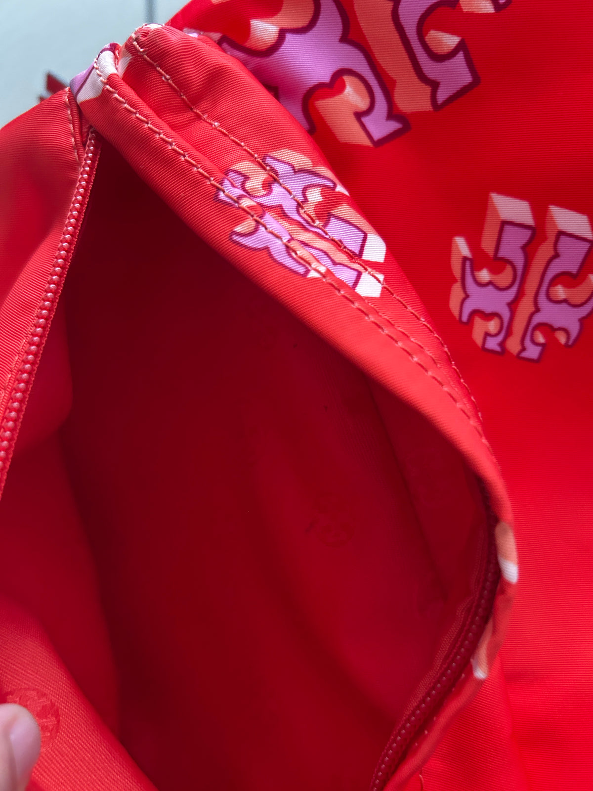 Tory Burch Ella Printed Backpack featuring a crazy logo allover pattern