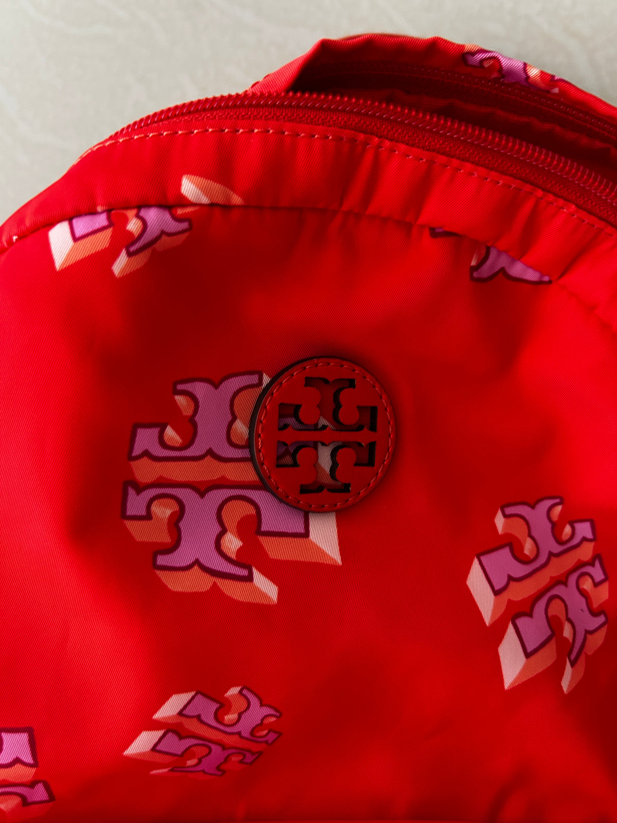 Tory Burch Ella Printed Backpack featuring a crazy logo allover pattern